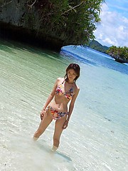 Asian teen models her hot thong bikini clad ass