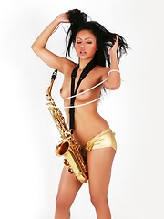 Janice in panties playing the saxophone topless