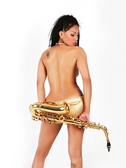 Janice in panties playing the saxophone topless