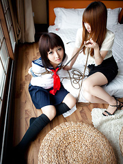 Dimdim Asian in uniform is tied in ropes by another sexy cupcake