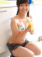 Sweet Ayana Tanigaki smiles and poses at the kitchen with banana