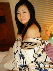 Nasty girl Emiko Koike seduces on the bed for cam